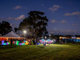 crowd, marquee and activities at evening event