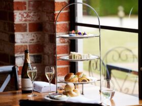 High Tea stand with delectable treats, two glasses of sparkling wine