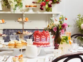 High tea set up with cakes, treats and mixed drinks