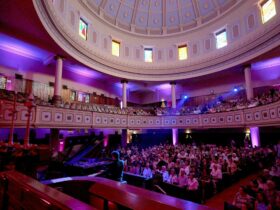 toorak synagogue, man at a piano, a dome with stained glass windows, people sitting in the audience