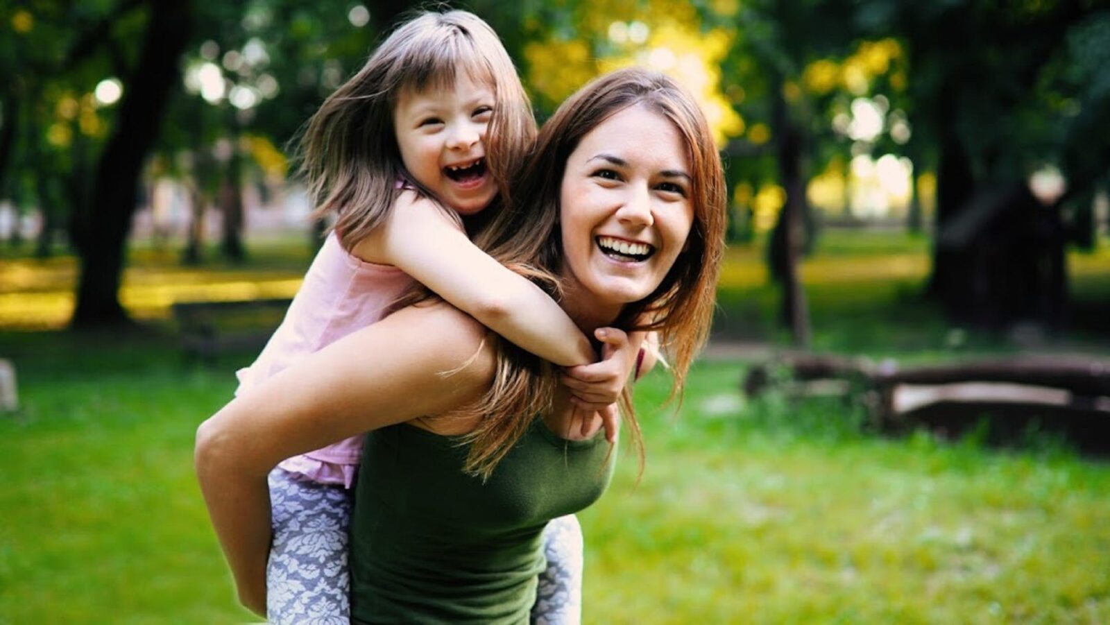 a woman and a child in the park smiling