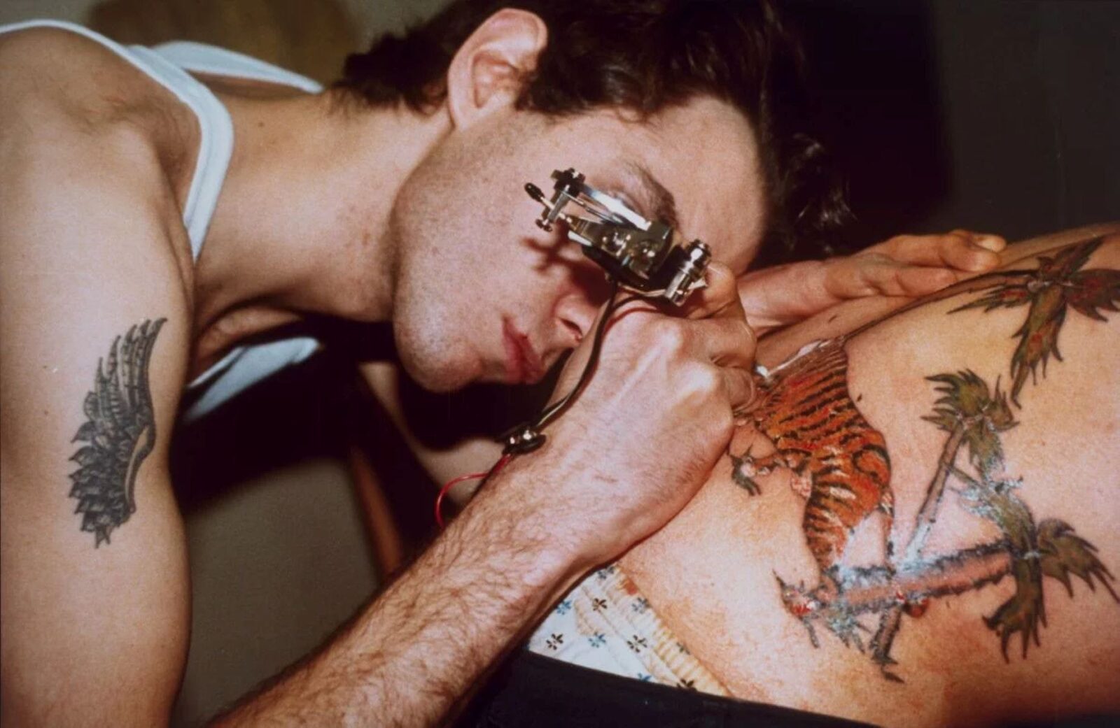 Tattoo artist tattooing a man's back