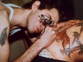 Tattoo artist tattooing a man's back