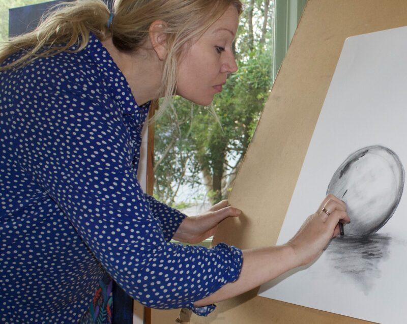 artist drawing with charcoal