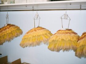 Four yellow tutus hanging in a line