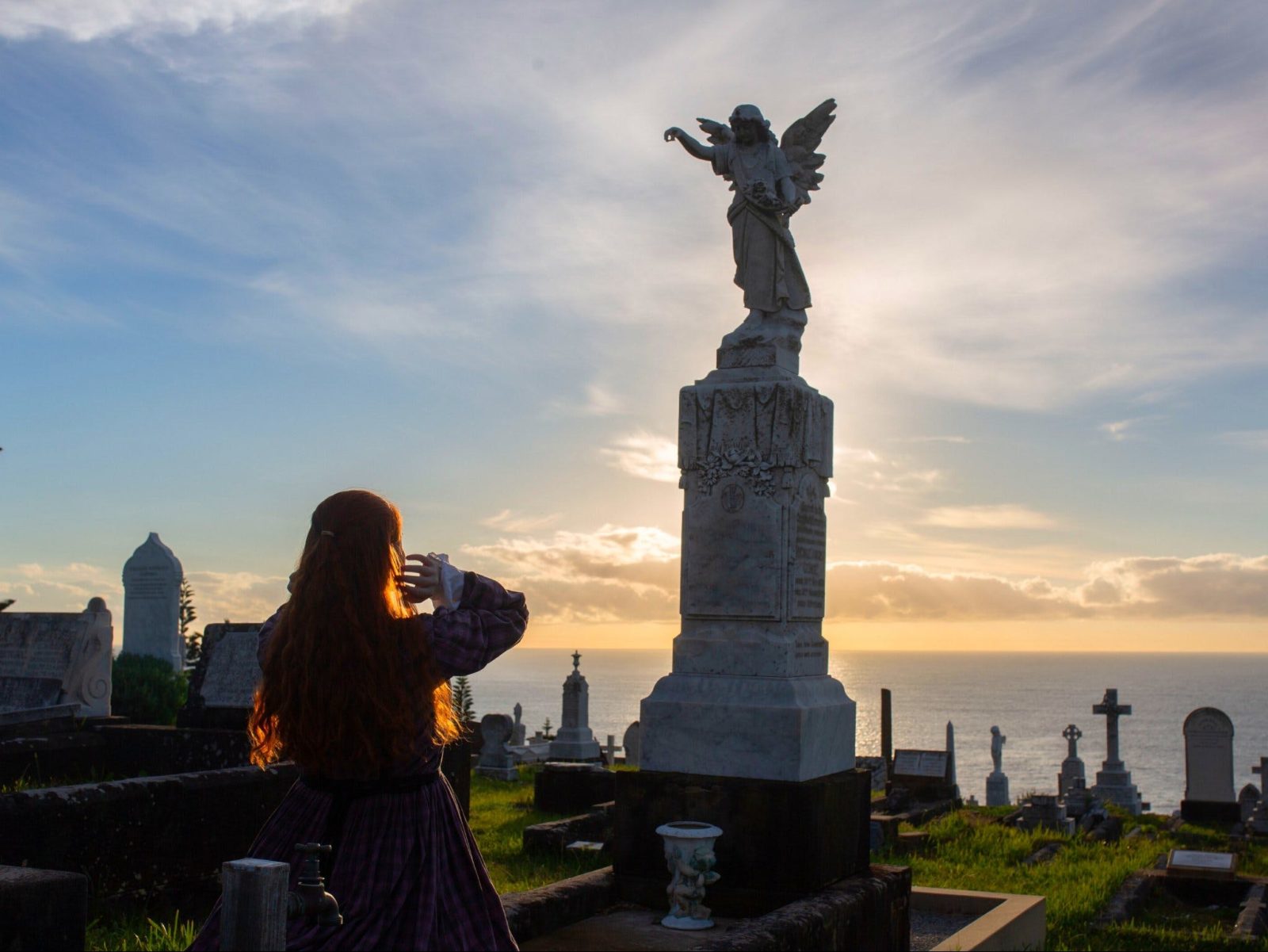 Anne Brontë (Casey Anne Martin) praying in the graveyard by an angel