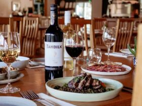 Plates of food and two bottles of wine at Tahbilk Estate Restaurant
