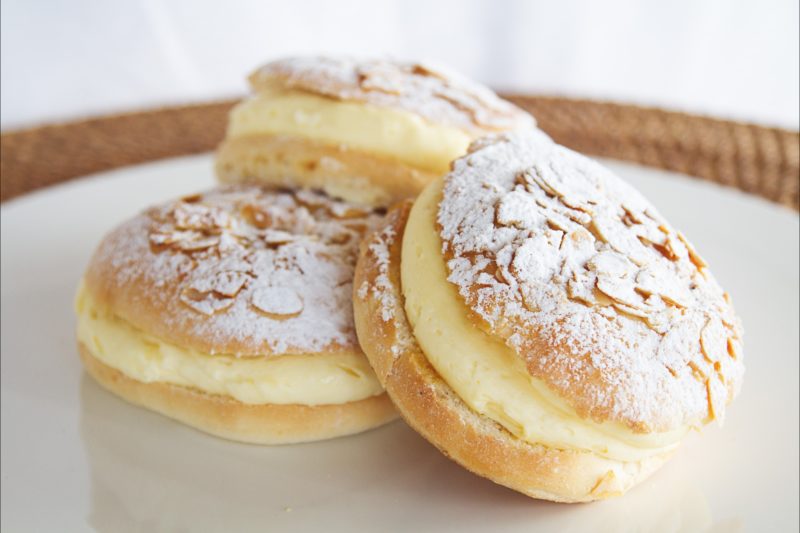 Beestings - melt-in-your-mouth buns filled with velvety custard and topped with toffeed almonds