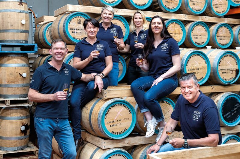 A picture of the Chief's Son team taken on the distillery floor amongst the French Oak barrels.