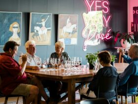 a group of people around a table enjoying wine