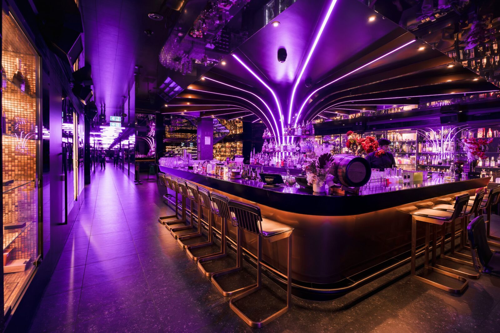 A purple neon lit cocktail bar