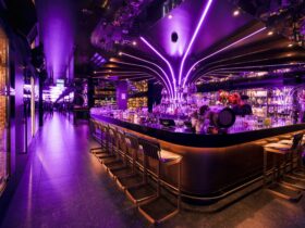 A purple neon lit cocktail bar