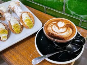 Cappuccino and traditional ricotta filled cannoli with local lemon and pistachio