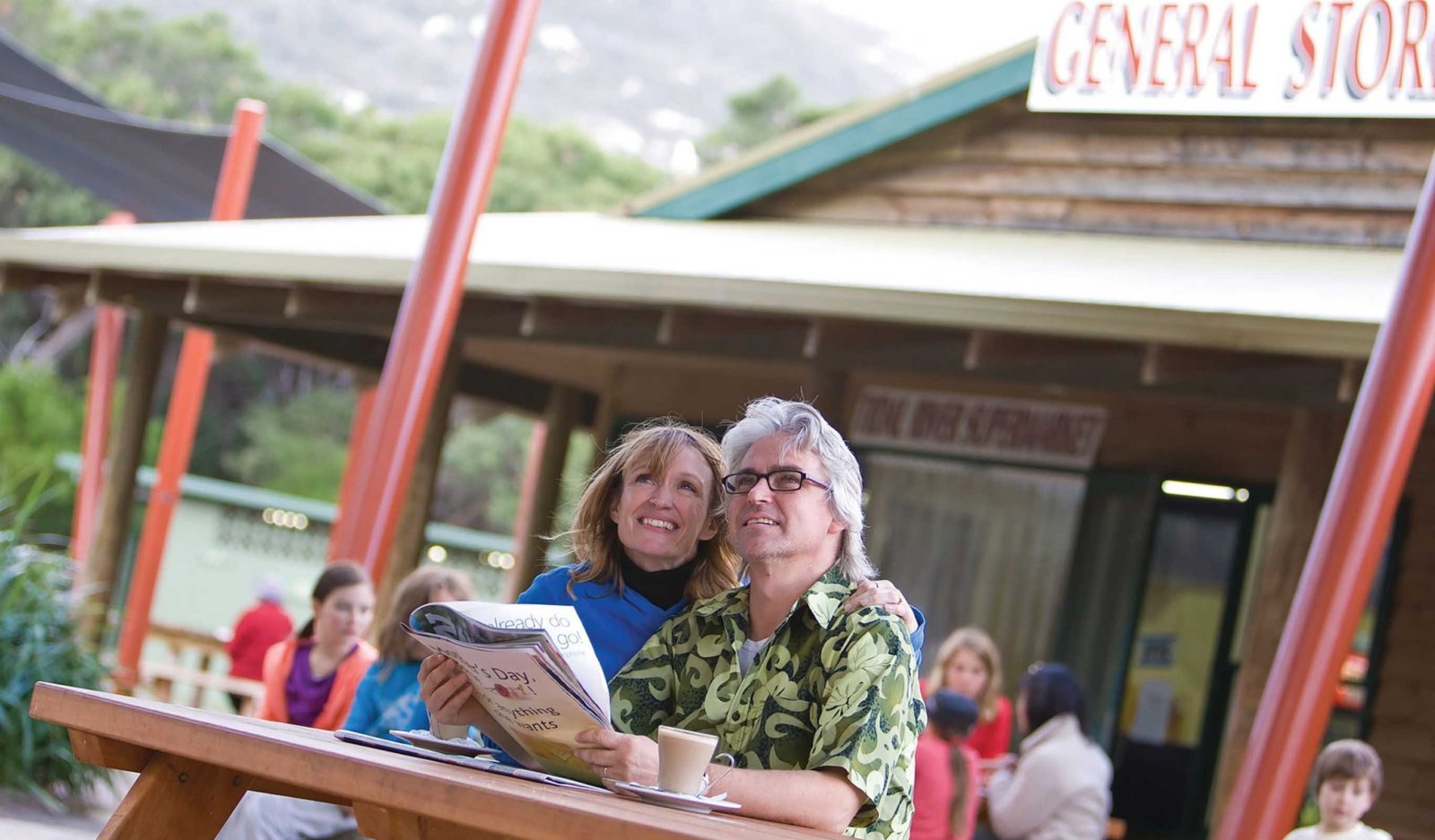 Couple Enjoying a Coffee Outside the Tidal River General Store