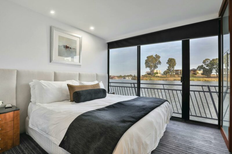 a bedroom inside a riverboat overlooking the water