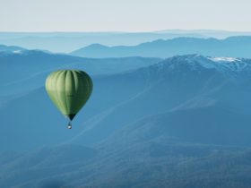 Green Hot Air Balloon Over Mansfield - Mt Buller in the Background