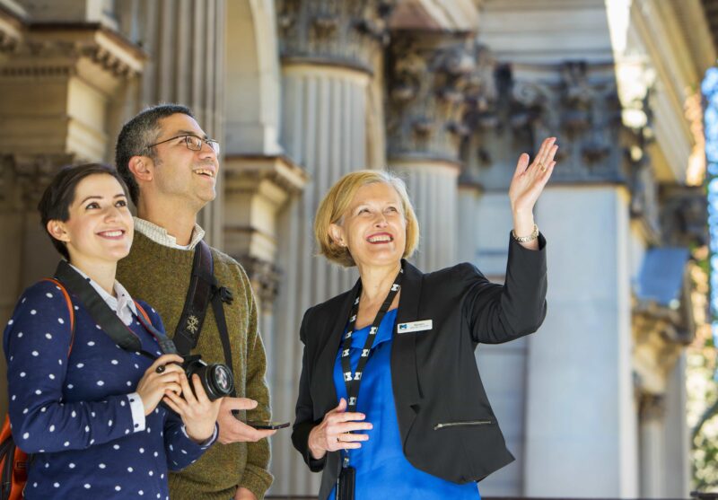 A Town Hall tour guide showing visitors the beautiful Portico