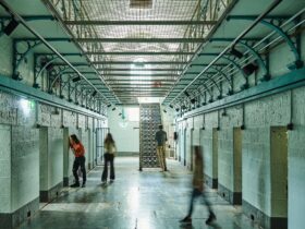4 visitors exploring in H Division at Pentridge Prison Tours