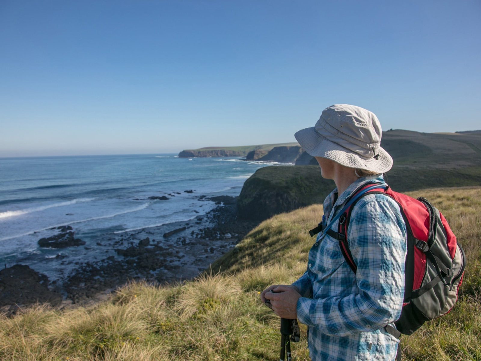 Hiker looking at ocean coastal views of walk from Flinders to Cape Schanck, Mornington Peninsual