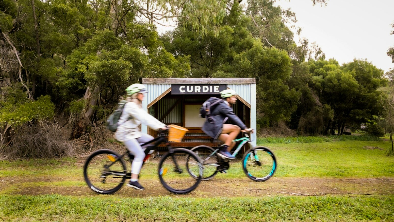 A man and a lady riding an ebike and a mountain bike along the Camperdown to Timboon Rail Trail