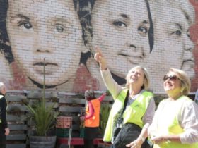 Two women look at a street mural in Ringwood
