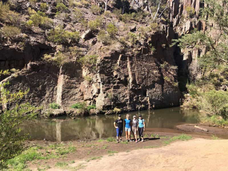 Three people standing in a gorge