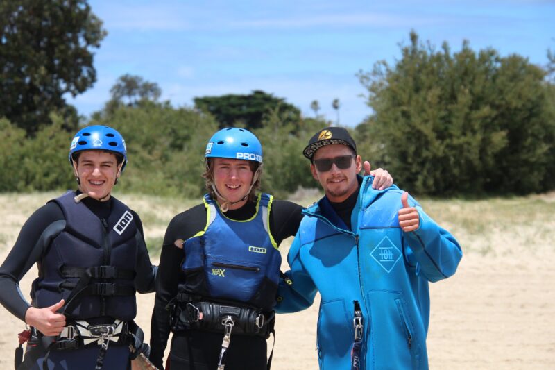 Instructor with students after lesson on beach