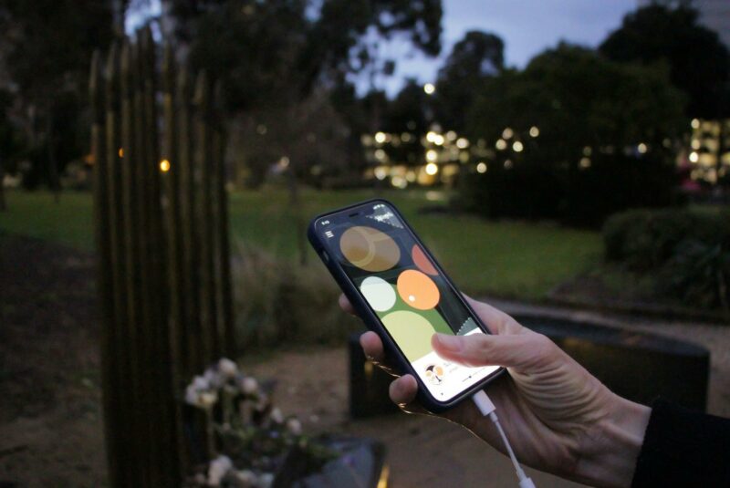 Listening to the Yalinguth app in Atherton Gardens, Fitzroy