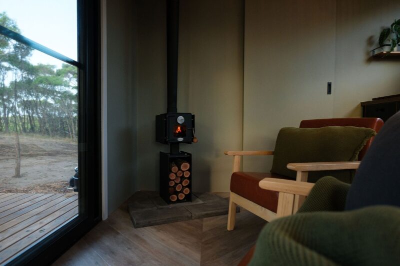 Mini wood heater burning with luxurious seats to look out the huge windows
