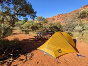 Small tent set up on red sand