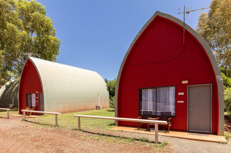 The exterior of two A-frame chalets painted red