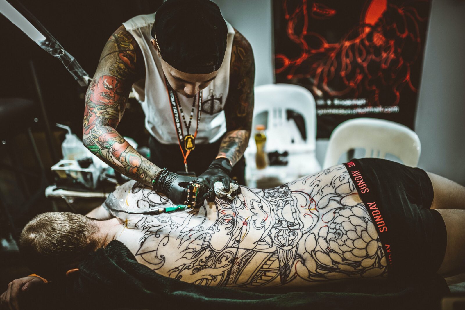 Artist tattooing back
