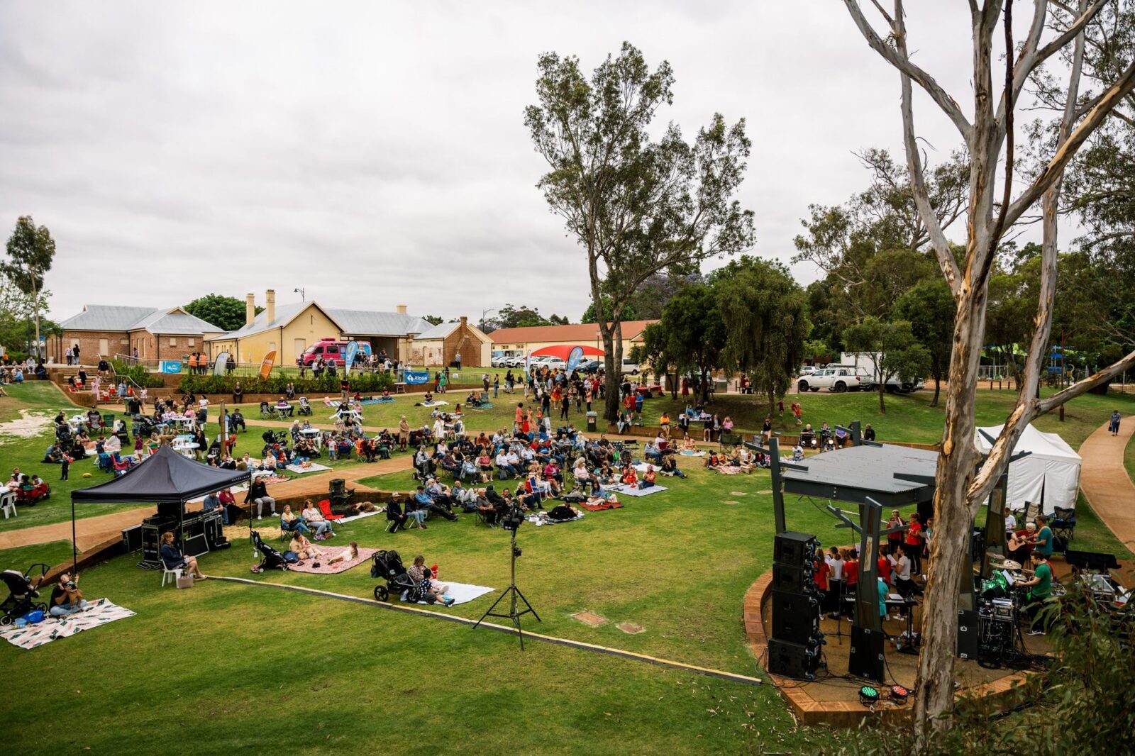 view of event attendees sitting on grass