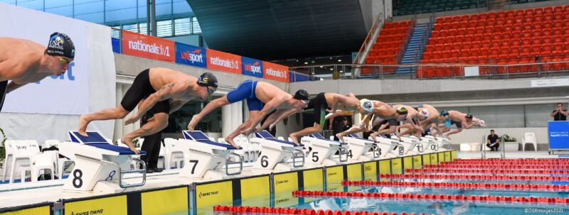 Swimmers diving off blocks at UniSport Nationals