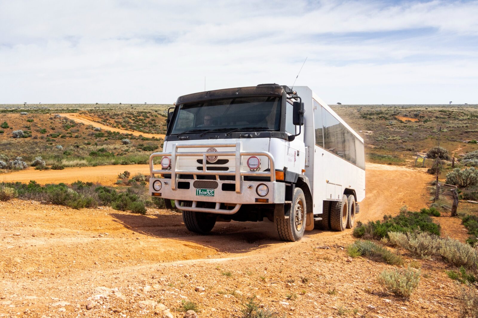 6WD coach tour vehicle driving on dirt road